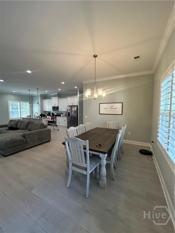 275 Heron Ct, Saint Marys, GA 31558 - dining space featuring ornamental molding, a chandelier, light tile patterned floors, and recessed lighting