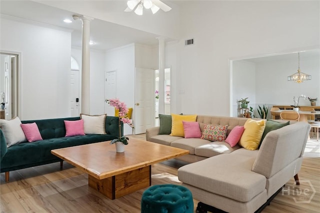 4 Jackson Ct, Savannah, GA 31405 - living area with decorative columns, a towering ceiling, light wood finished floors, a ceiling fan, and crown molding
