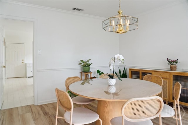 4 Jackson Ct, Savannah, GA 31405 - dining space with a chandelier, light wood-style floors, and crown molding