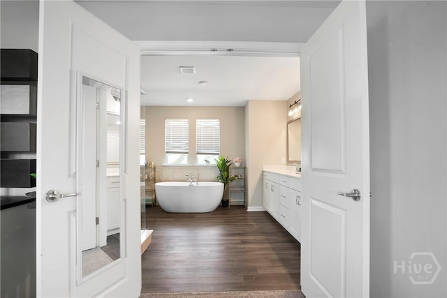 11 Shoefstall St, Savannah, GA 31407 - bathroom with vanity, a soaking tub, and wood finished floors