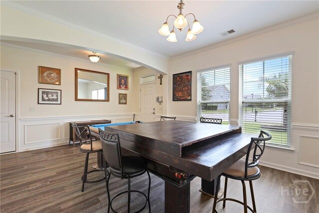 30 Melody Dr, Pooler, GA 31322 - dining area featuring arched walkways, dark wood-style flooring, healthy amount of natural light, a chandelier, and wainscoting
