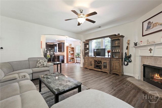 30 Melody Dr, Pooler, GA 31322 - living area with arched walkways, a ceiling fan, a tile fireplace, and wood finished floors