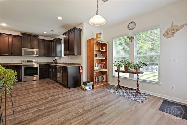 30 Melody Dr, Pooler, GA 31322 - kitchen with stainless steel appliances, wood finished floors, healthy amount of natural light, dark brown cabinetry, and recessed lighting