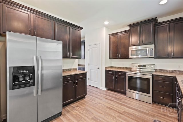 30 Melody Dr, Pooler, GA 31322 - kitchen featuring appliances with stainless steel finishes, light wood finished floors, dark brown cabinetry, and recessed lighting