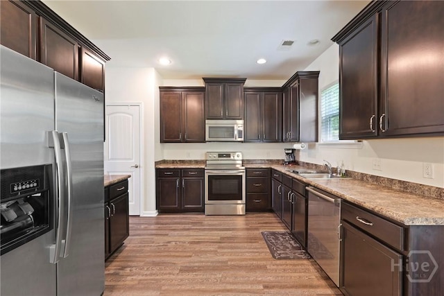 30 Melody Dr, Pooler, GA 31322 - kitchen with appliances with stainless steel finishes, dark brown cabinets, light wood-style floors, and recessed lighting