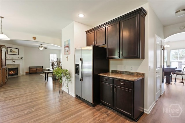 30 Melody Dr, Pooler, GA 31322 - kitchen with stainless steel fridge, a ceiling fan, wood finished floors, arched walkways, and dark countertops