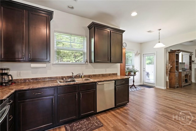 30 Melody Dr, Pooler, GA 31322 - kitchen with stainless steel dishwasher, light wood-style flooring, dark brown cabinets, dark countertops, and recessed lighting