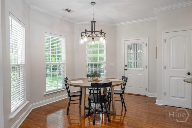 210 Windsong Dr, Richmond Hill, GA 31324 - dining space featuring dark wood-style floors, crown molding, and a chandelier