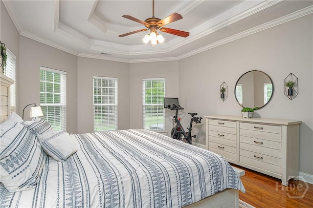 210 Windsong Dr, Richmond Hill, GA 31324 - bedroom featuring wood finished floors, ornamental molding, a tray ceiling, and a ceiling fan
