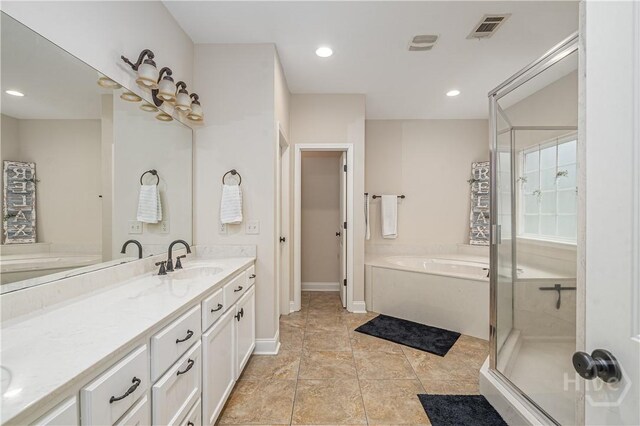 210 Windsong Dr, Richmond Hill, GA 31324 - bathroom with a garden tub, double vanity, a stall shower, recessed lighting, and tile patterned floors