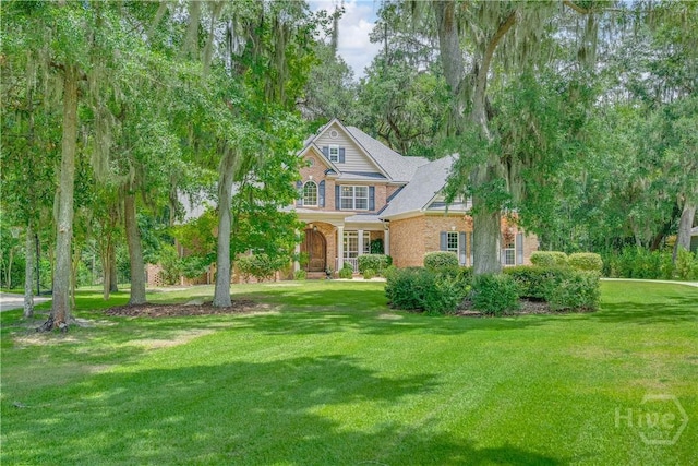 210 Windsong Dr, Richmond Hill, GA 31324 - view of front of property featuring a front yard and brick siding