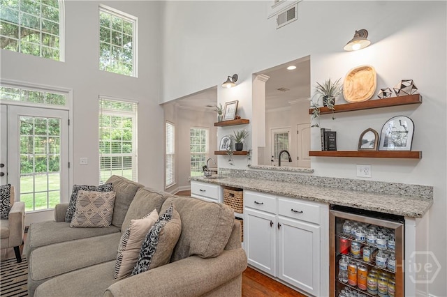 210 Windsong Dr, Richmond Hill, GA 31324 - bar featuring plenty of natural light, wine cooler, a high ceiling, and recessed lighting