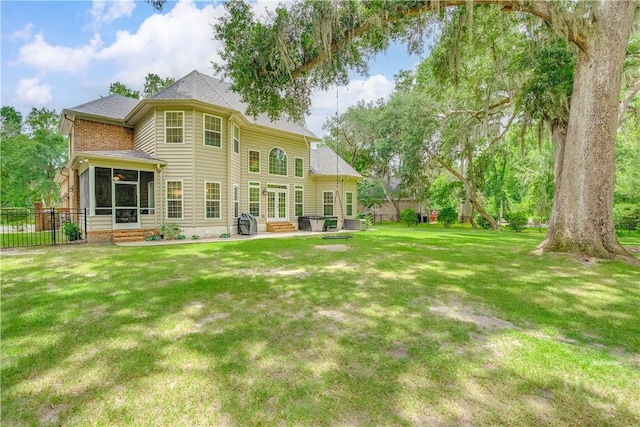210 Windsong Dr, Richmond Hill, GA 31324 - back of house with a sunroom, a patio area, and entry steps