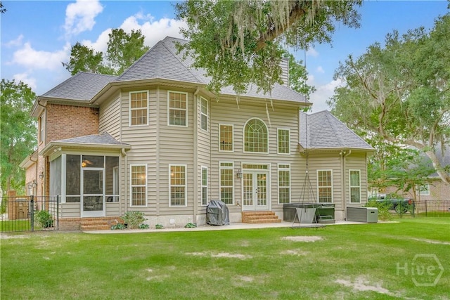 210 Windsong Dr, Richmond Hill, GA 31324 - back of property with french doors, a sunroom, a patio area, entry steps, and a shingled roof