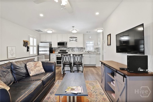 536 E Harris St, Savannah, GA 31401 - living room with ceiling fan, light wood-type flooring, and recessed lighting