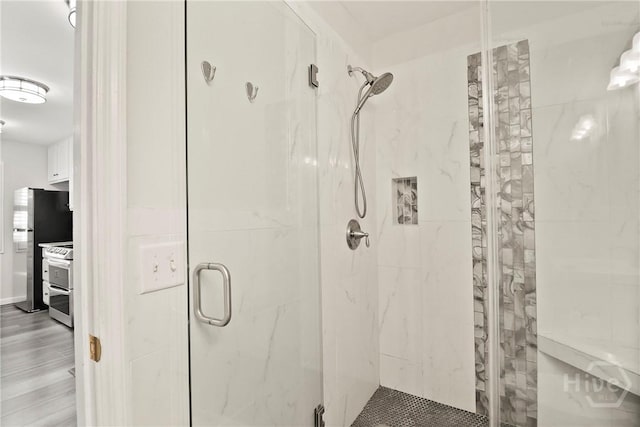 536 E Harris St, Savannah, GA 31401 - bathroom featuring a marble finish shower and wood finished floors