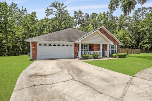 140 Kettle Creek Ln, Midway, GA 31320 - ranch-style home with covered porch, concrete driveway, an attached garage, brick siding, and view of scattered trees