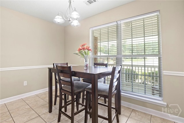 140 Kettle Creek Ln, Midway, GA 31320 - dining area with light tile patterned flooring and a chandelier