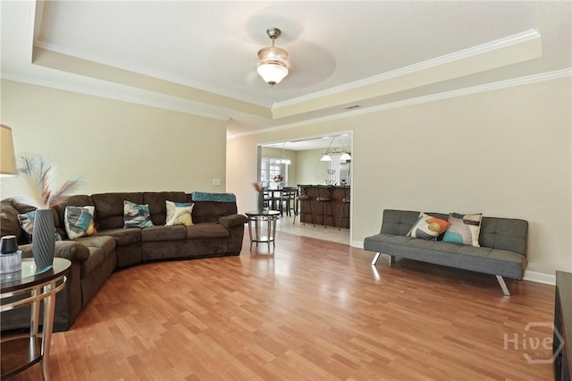 140 Kettle Creek Ln, Midway, GA 31320 - living area with a raised ceiling, light wood finished floors, ornamental molding, and ceiling fan