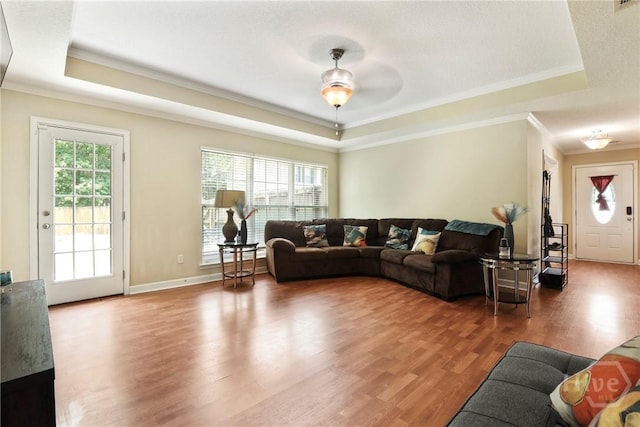 140 Kettle Creek Ln, Midway, GA 31320 - living room featuring a raised ceiling, ornamental molding, and wood finished floors