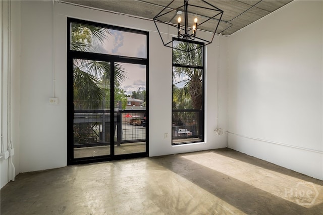 2406 De Soto Ave Unit B, Savannah, GA 31401 - empty room with concrete floors, a chandelier, and healthy amount of natural light