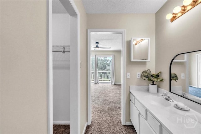 3005 River Dr Unit 302, Savannah, GA 31404 - bathroom with a textured ceiling, vanity, and a ceiling fan