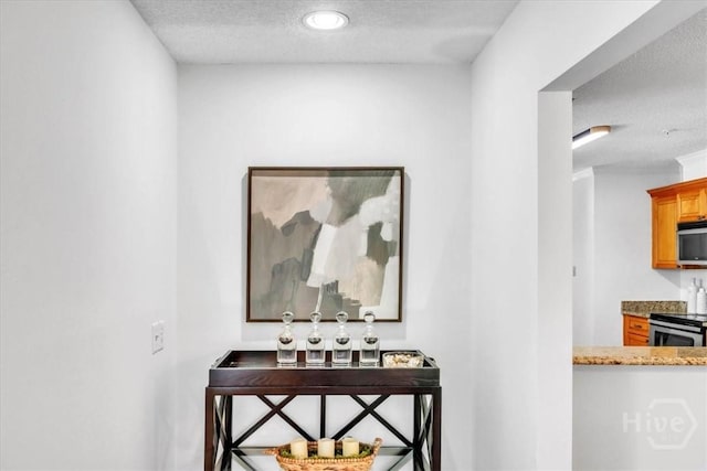 3005 River Dr Unit 302, Savannah, GA 31404 - hallway featuring a textured ceiling