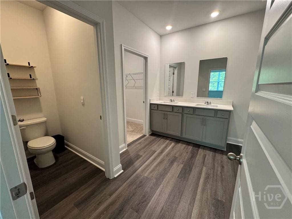 756 Logging Hill Dr, Richmond Hill, GA 31324 - full bathroom with wood finished floors, double vanity, recessed lighting, and a walk in closet