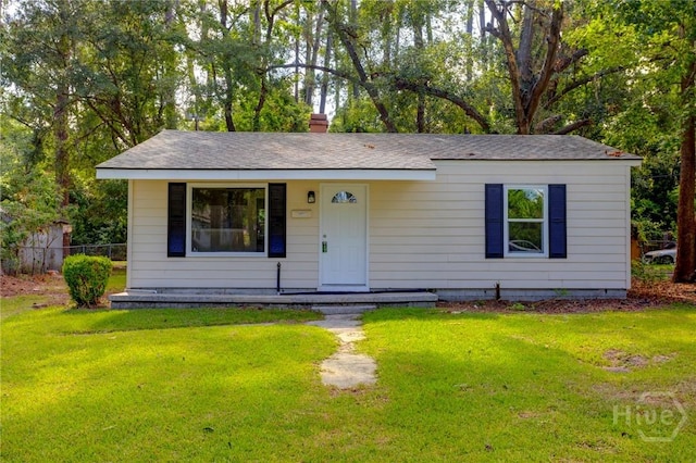 5317 Athena Dr, Savannah, GA 31404 - view of front of house with a front lawn, roof with shingles, and a chimney
