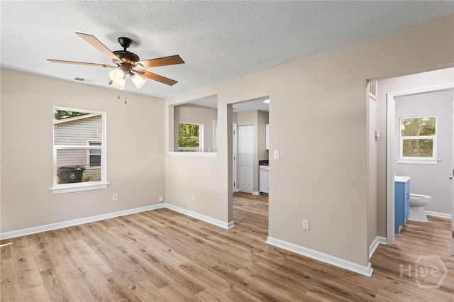 5317 Athena Dr, Savannah, GA 31404 - empty room with plenty of natural light, ceiling fan, light wood-style floors, and a textured ceiling