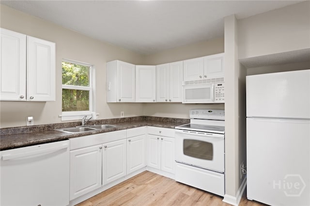 5317 Athena Dr, Savannah, GA 31404 - kitchen with white appliances, light wood-style floors, white cabinetry, and dark countertops
