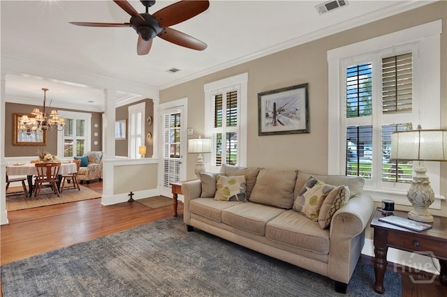 1507 E 49th St, Savannah, GA 31404 - living room with healthy amount of natural light, wood finished floors, a chandelier, and crown molding