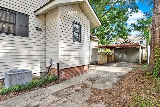 1507 E 49th St, Savannah, GA 31404 - view of side of property featuring a central AC unit and a carport