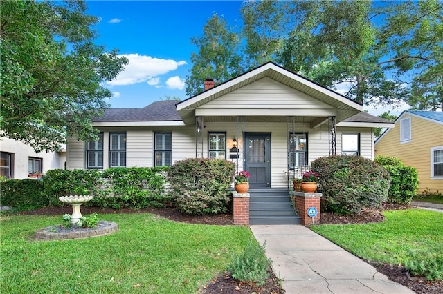 1507 E 49th St, Savannah, GA 31404 - bungalow featuring a front yard, a chimney, and covered porch