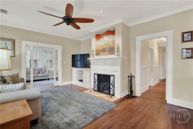 1507 E 49th St, Savannah, GA 31404 - living area featuring ornamental molding, ceiling fan, wood finished floors, and a fireplace with flush hearth