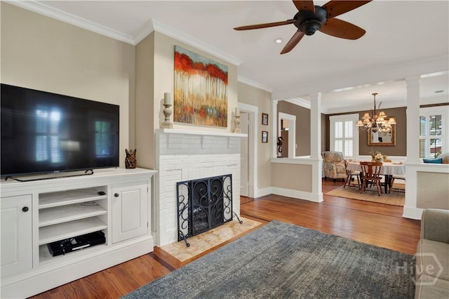 1507 E 49th St, Savannah, GA 31404 - living room with decorative columns, wood finished floors, crown molding, a chandelier, and a ceiling fan