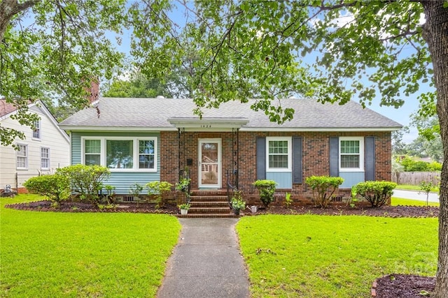 1424 E 53rd St, Savannah, GA 31404 - view of front of home with a front yard, brick siding, and roof with shingles