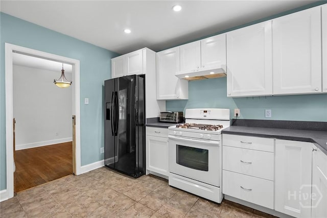 1424 E 53rd St, Savannah, GA 31404 - kitchen featuring white gas range, black refrigerator with ice dispenser, under cabinet range hood, dark countertops, and white cabinetry