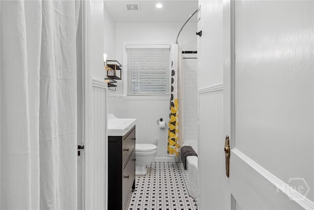 1424 E 53rd St, Savannah, GA 31404 - full bath featuring vanity, a wainscoted wall, and shower / tub combo with curtain