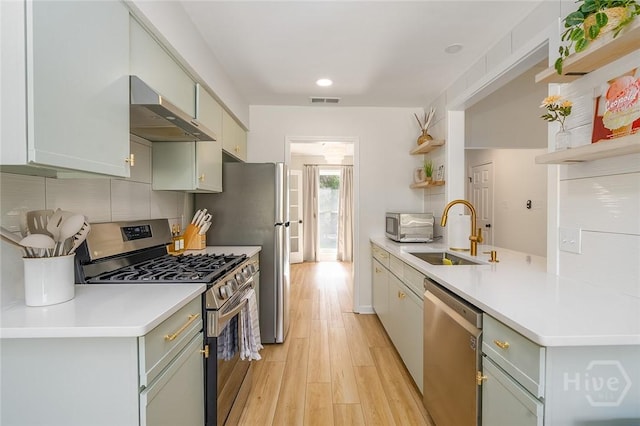 27 Bryan Wood Cir, Savannah, GA 31410 - kitchen featuring stainless steel appliances, wall chimney range hood, open shelves, light wood-type flooring, and recessed lighting