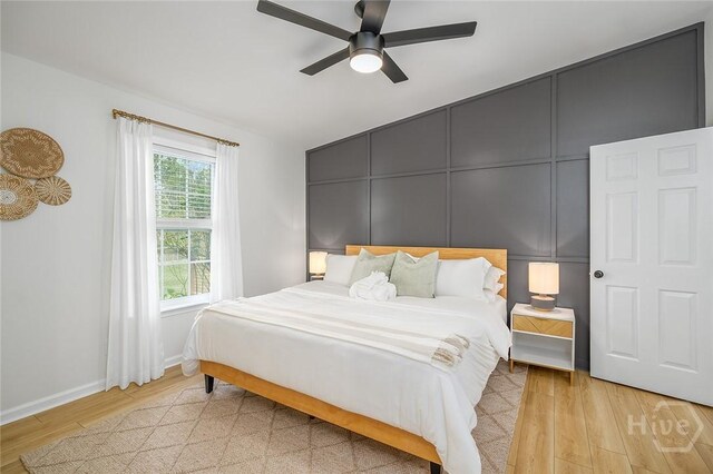 27 Bryan Wood Cir, Savannah, GA 31410 - bedroom with light wood-style floors, ceiling fan, and a decorative wall