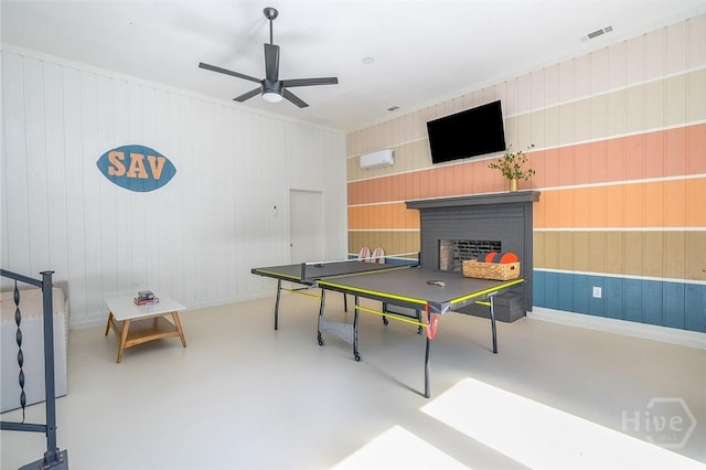 27 Bryan Wood Cir, Savannah, GA 31410 - playroom featuring a brick fireplace, concrete flooring, ceiling fan, and wooden walls