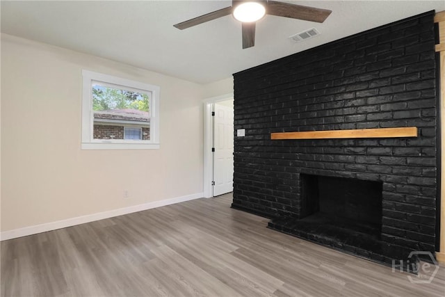 114 Paradise Dr, Savannah, GA 31406 - unfurnished living room featuring ceiling fan, wood finished floors, and a fireplace