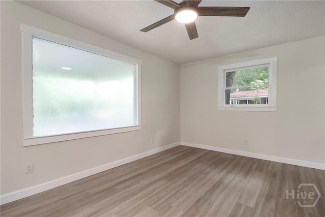 114 Paradise Dr, Savannah, GA 31406 - spare room with wood finished floors, a ceiling fan, and a textured ceiling