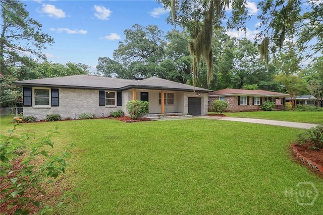 114 Paradise Dr, Savannah, GA 31406 - single story home with an attached garage, driveway, a front lawn, and brick siding