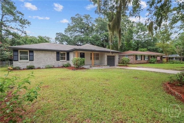114 Paradise Dr, Savannah, GA 31406 - ranch-style home featuring a garage, concrete driveway, a front lawn, and brick siding