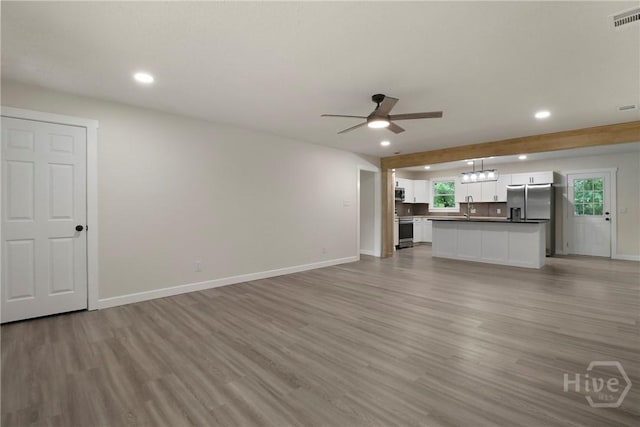 114 Paradise Dr, Savannah, GA 31406 - unfurnished living room with recessed lighting, a ceiling fan, and light wood-style flooring