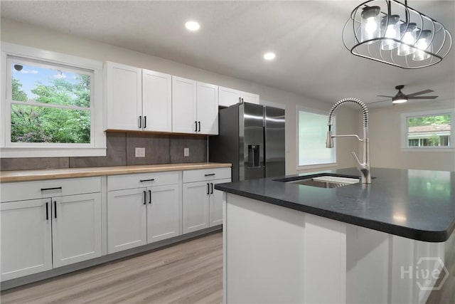 114 Paradise Dr, Savannah, GA 31406 - kitchen with stainless steel fridge with ice dispenser, light wood-style floors, recessed lighting, white cabinetry, and a ceiling fan