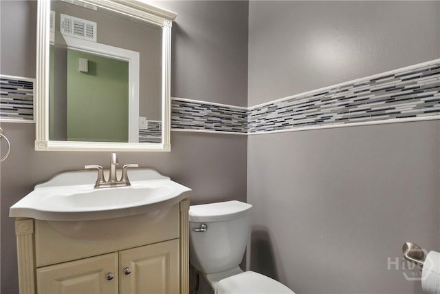 5012 Spartan Dr, Savannah, GA 31404 - bathroom with vanity, tile walls, and wainscoting