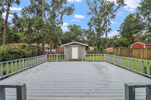 5012 Spartan Dr, Savannah, GA 31404 - deck featuring a storage shed, a fenced backyard, and view of wooded area